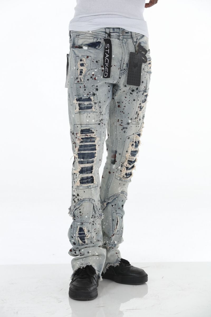 Close-up of light blue paint splatter pattern on Stacked Flare Ripped Jeans