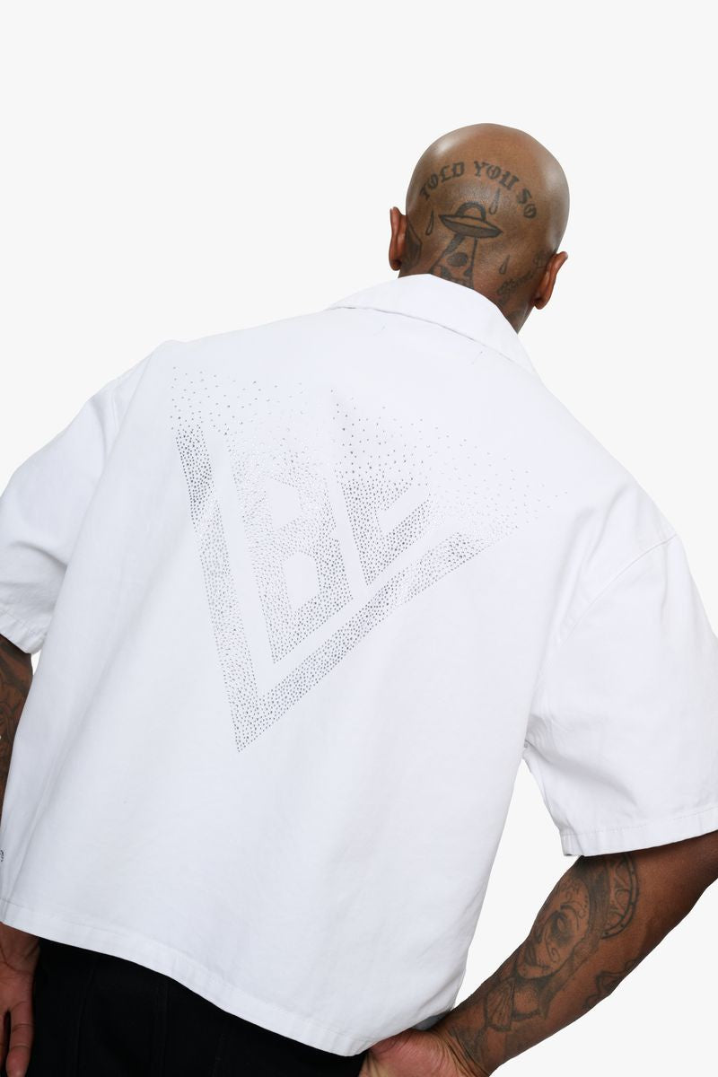A close-up view of the Valabasas Shine White Button Down shirt showcasing its crisp white fabric and classic button-down design
