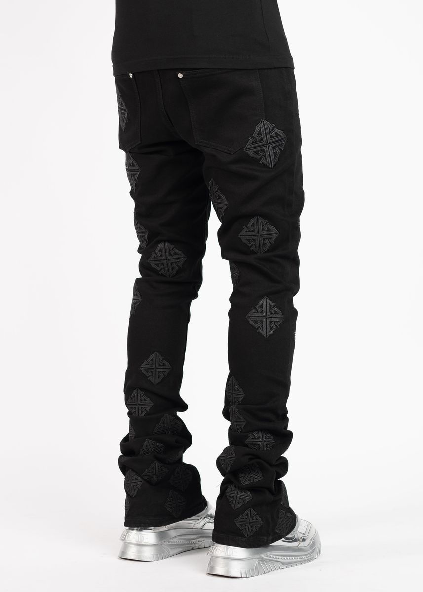 Close-up of the back pockets of Guapi All Black Icon Stacked Denim Jeans with embroidered logo