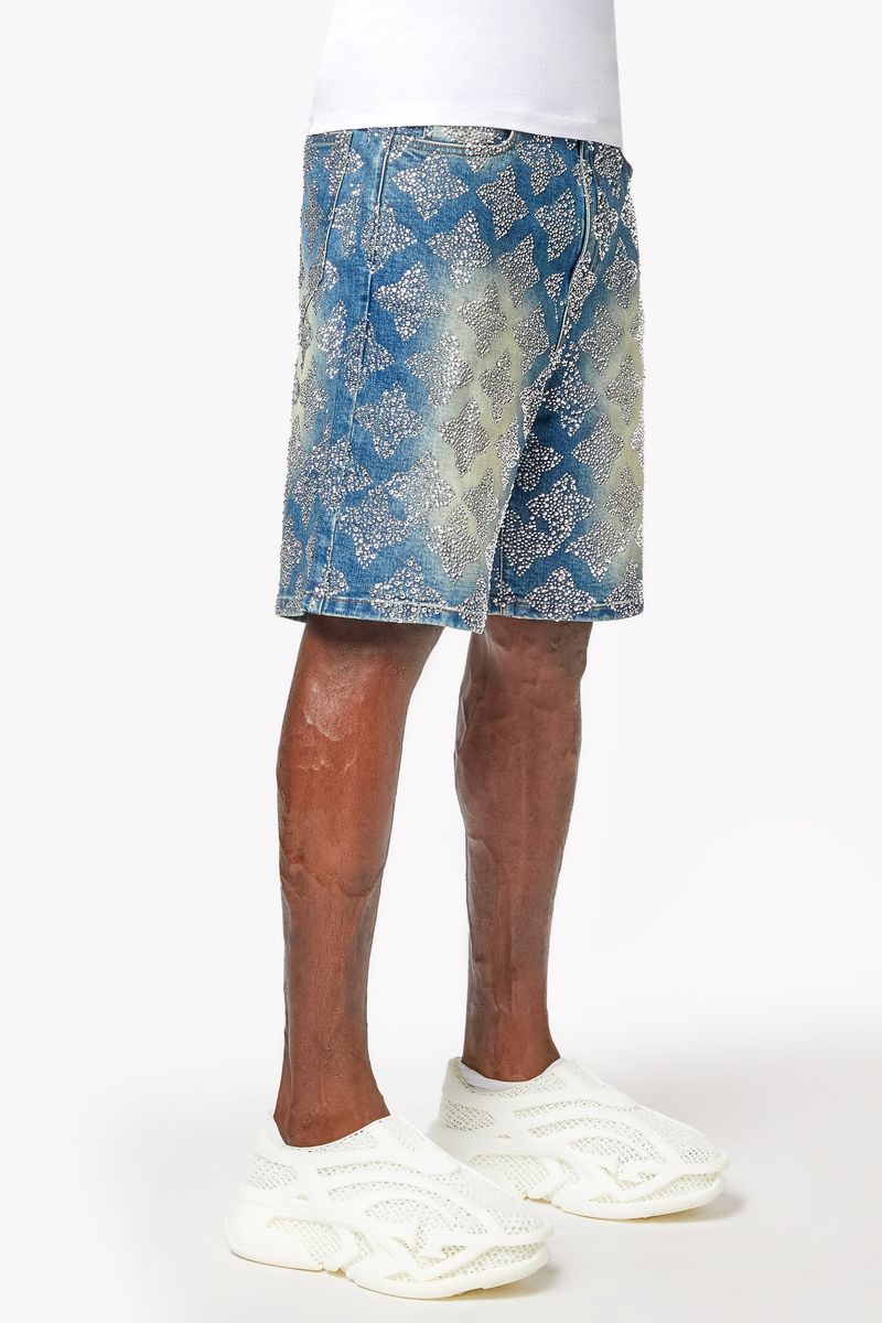 Side profile highlighting the textured embellishments and relaxed fit of vintage blue denim shorts