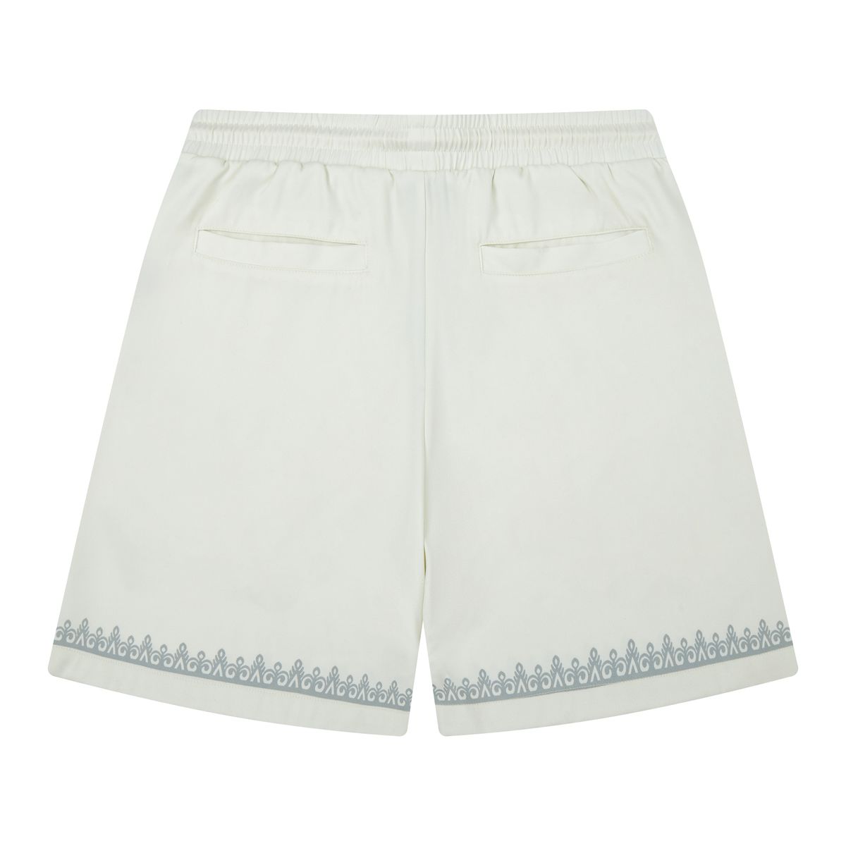 Close-up of the Almost Someday logo on the Daydream Cream Shorts with detailed stitching