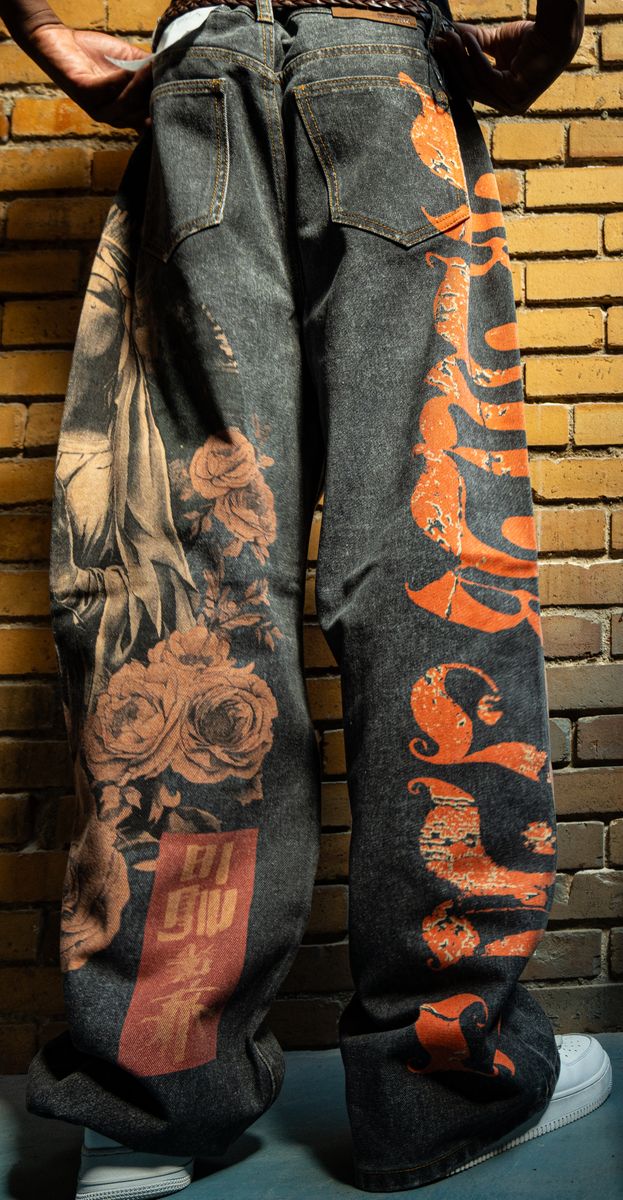 Full-length image of Amor Jeans Black Baggy Jeans displayed on a model emphasizing the stylish digital print and relaxed style