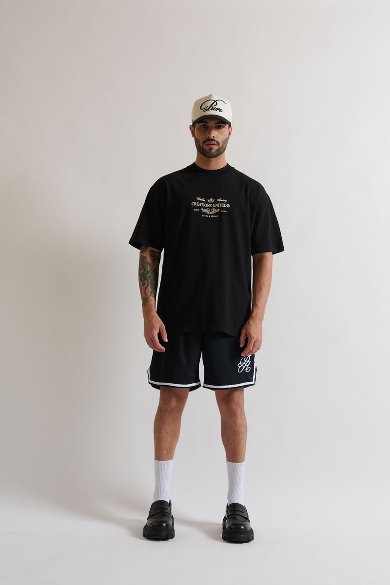 Side profile of the PURE Monclair Black Tee emphasizing its oversized fit and comfortable cotton material
