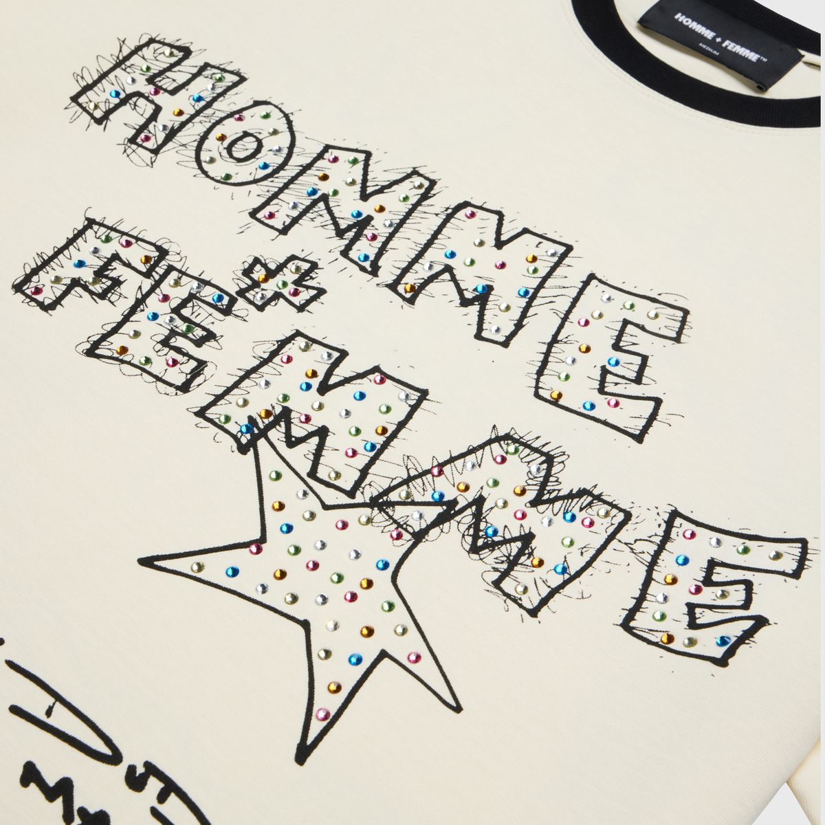 Homme + Femme Yearbook White Tee folded on a wooden table