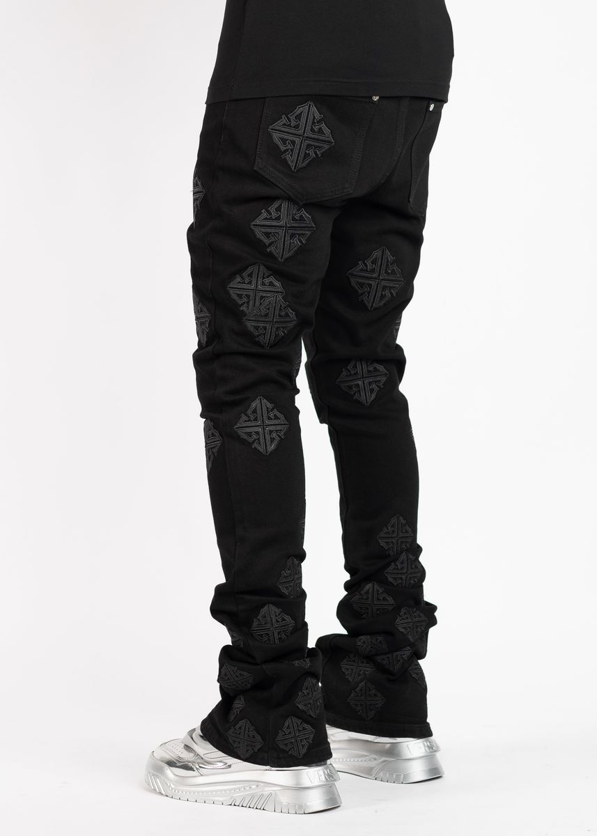 Side view of Guapi All Black Icon Stacked Denim Jeans showing the stacked fit and black wash