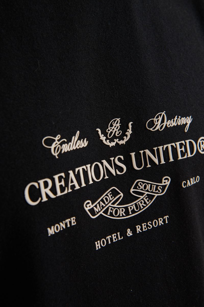 Model wearing the PURE Monclair Black Tee illustrating its relaxed oversized fit in everyday styling
