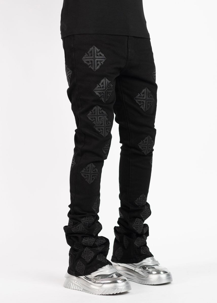 Guapi All Black Icon Stacked Denim Jeans styled with white sneakers and a black t-shirt