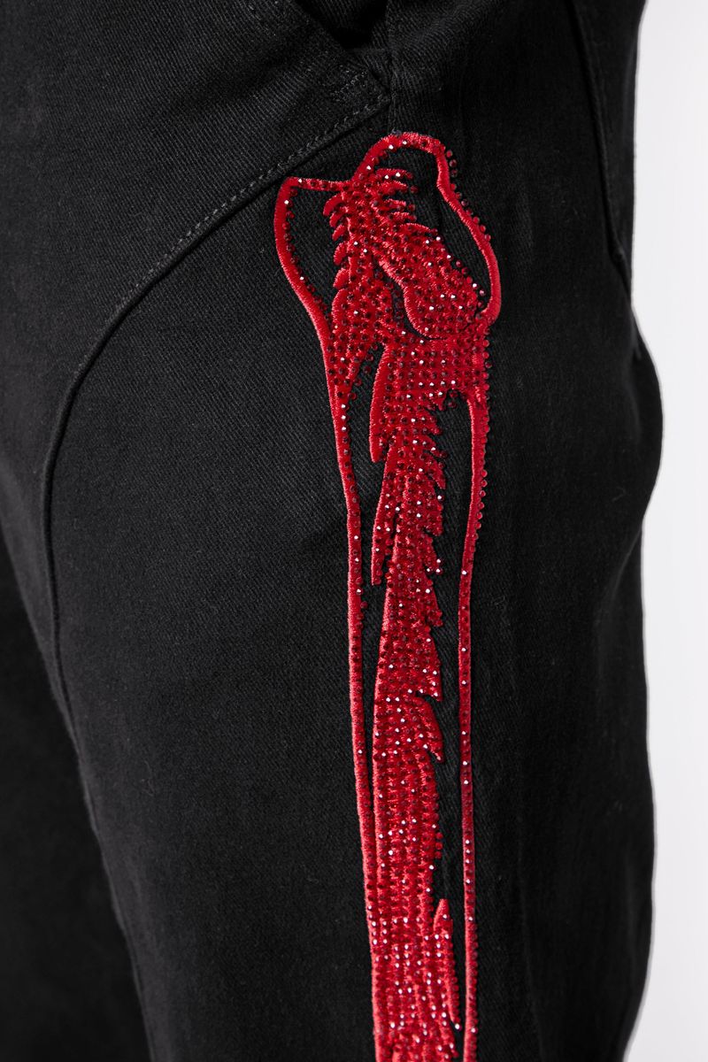 One-of-a-kind black denim jeans with intricate embroidery and standout aesthetic