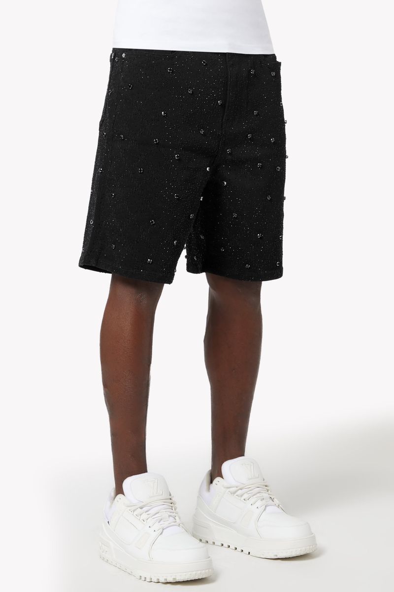 Guapi All Black Embellished Denim Shorts featuring intricate embellishments, distressed detailing, and stylish cut-off design for a trendy summer look