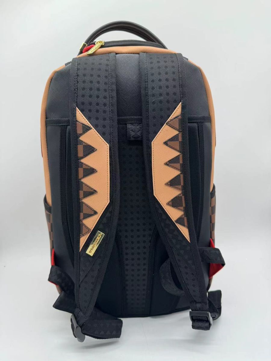 Side angle of the Sprayground Hypeshark VSM Backpack highlighting its sturdy construction and practical size of 18 x 115 x 65%