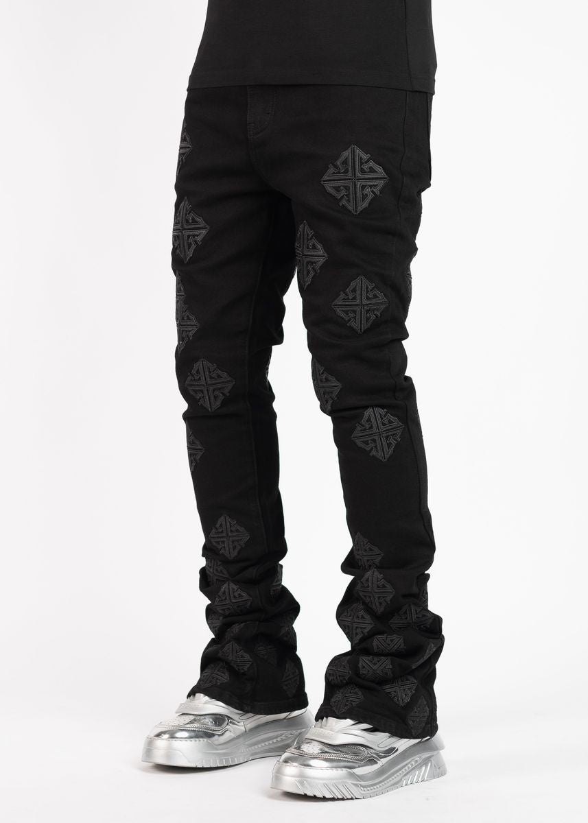Front view of Guapi All Black Icon Stacked Denim Jeans with distressed details and logo patch