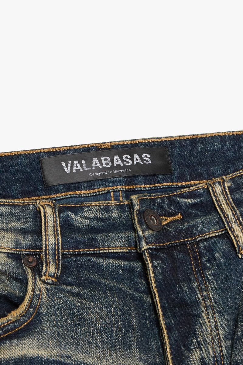 Stacked denim jeans in dark vintage wash by Valabasas, showcasing tearaway feature and stylish construction