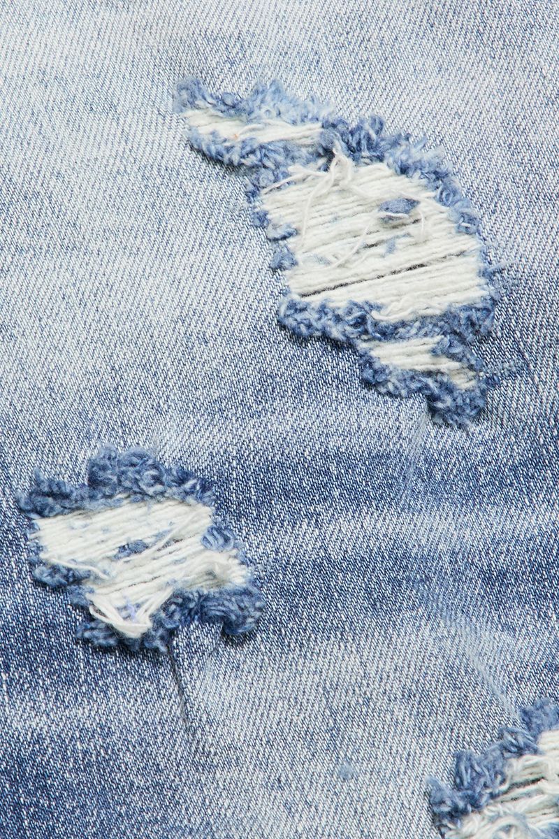 Close-up view of Valabasas Briggs denim jeans showcasing the flared cut and light blue wash