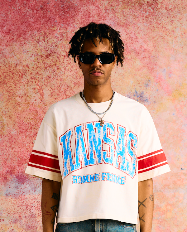 Spring 2025 collection cropped off white tee with Kansas print, varsity sleeve stripes, and a vintage stone wash finish