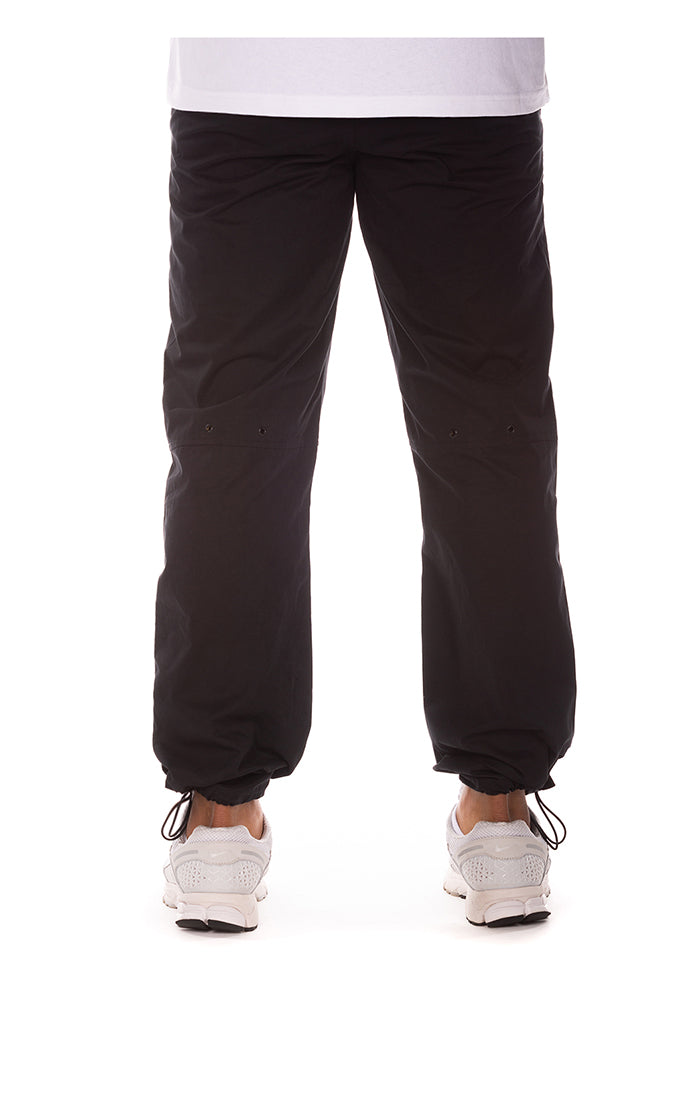 Close-up of the black BB ISS Pants showing the high-quality fabric and branding details for the Billionaire Boy's Club collection