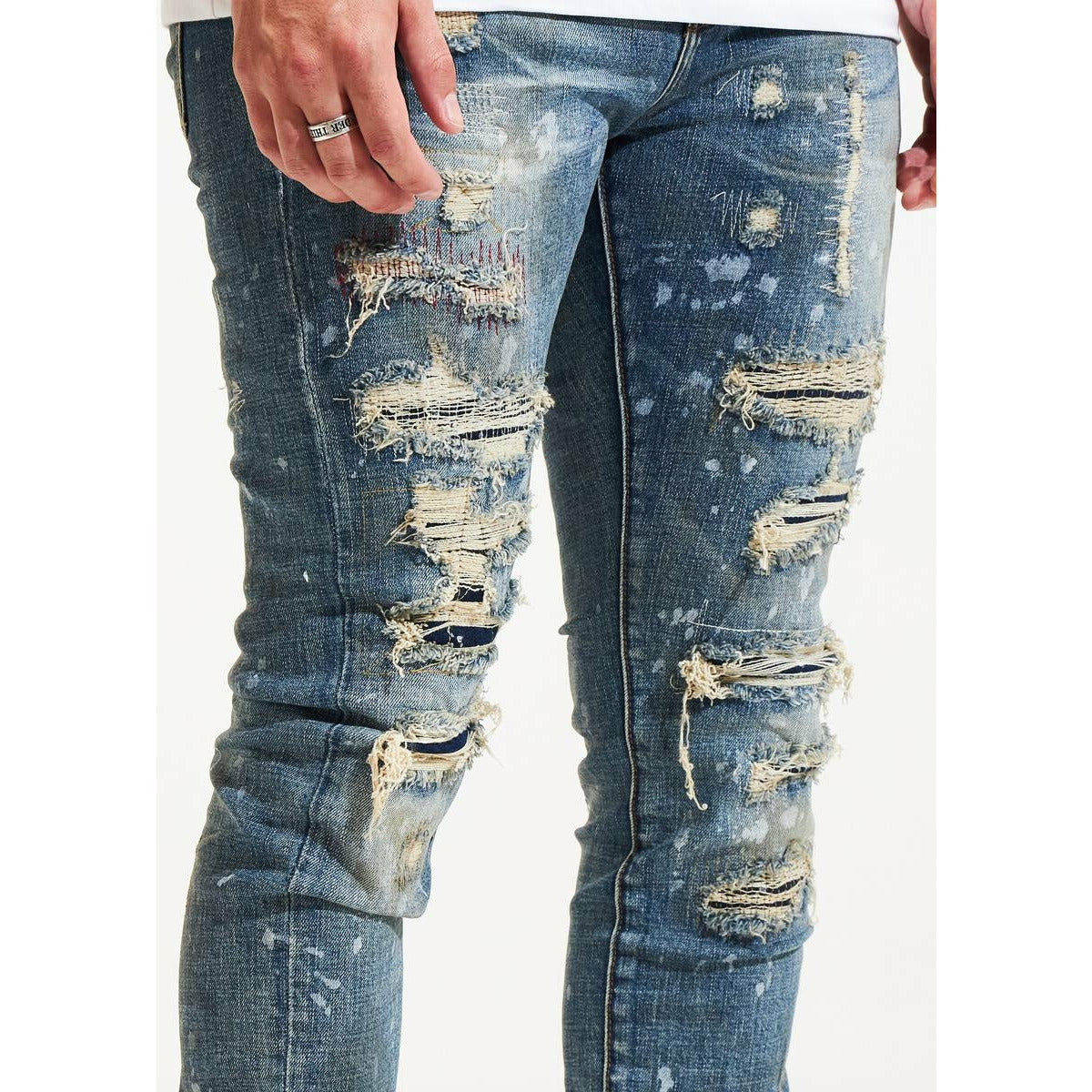 Embellish Cedric Blue Ripped Denim Jeans (EMBSP122-102) folded and styled with a leather belt