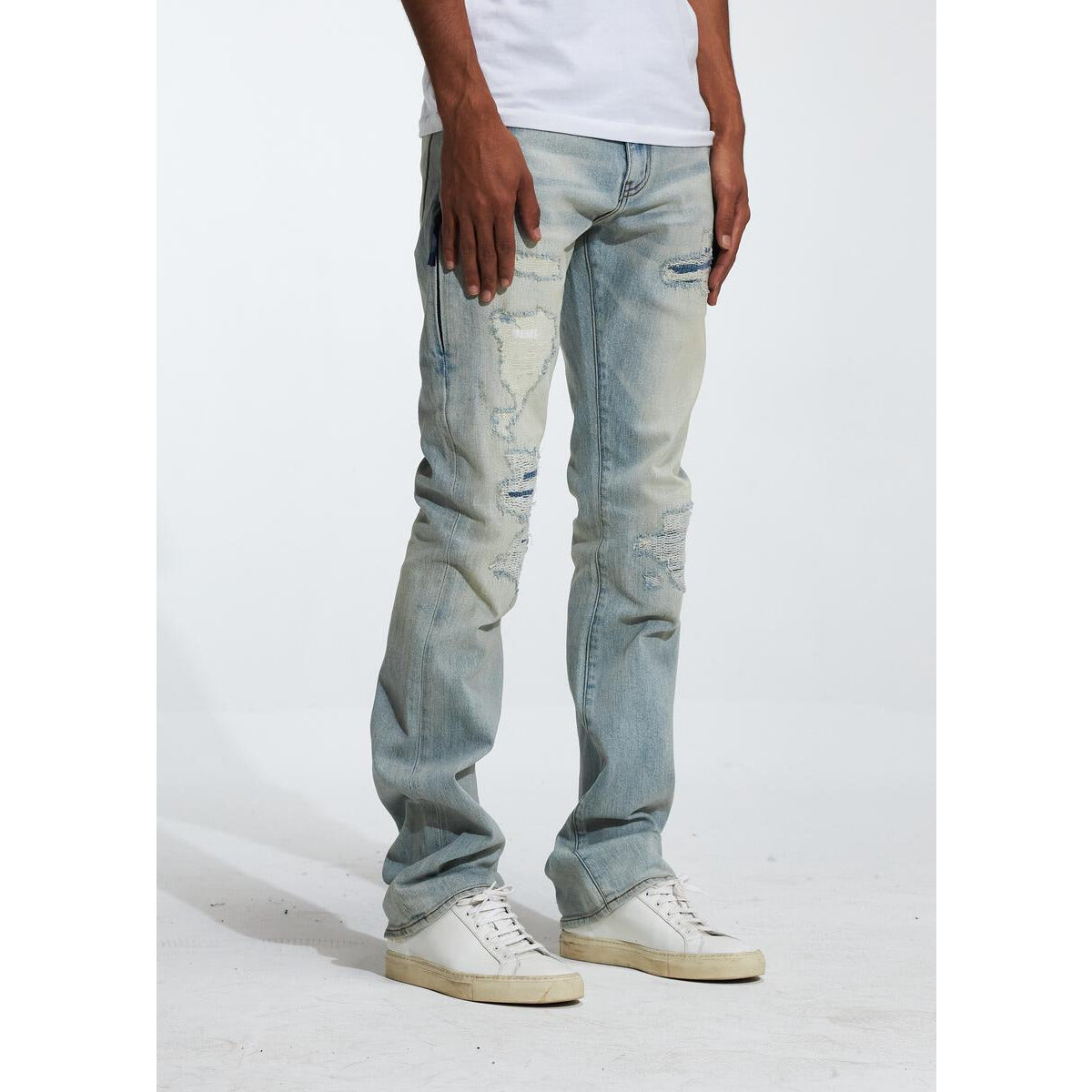 Embellish Hills Blue Wash Denim (EMBF222-15) displayed on a mannequin in a well-lit showroom with a distressed and faded finish, showcasing its unique style and detailing