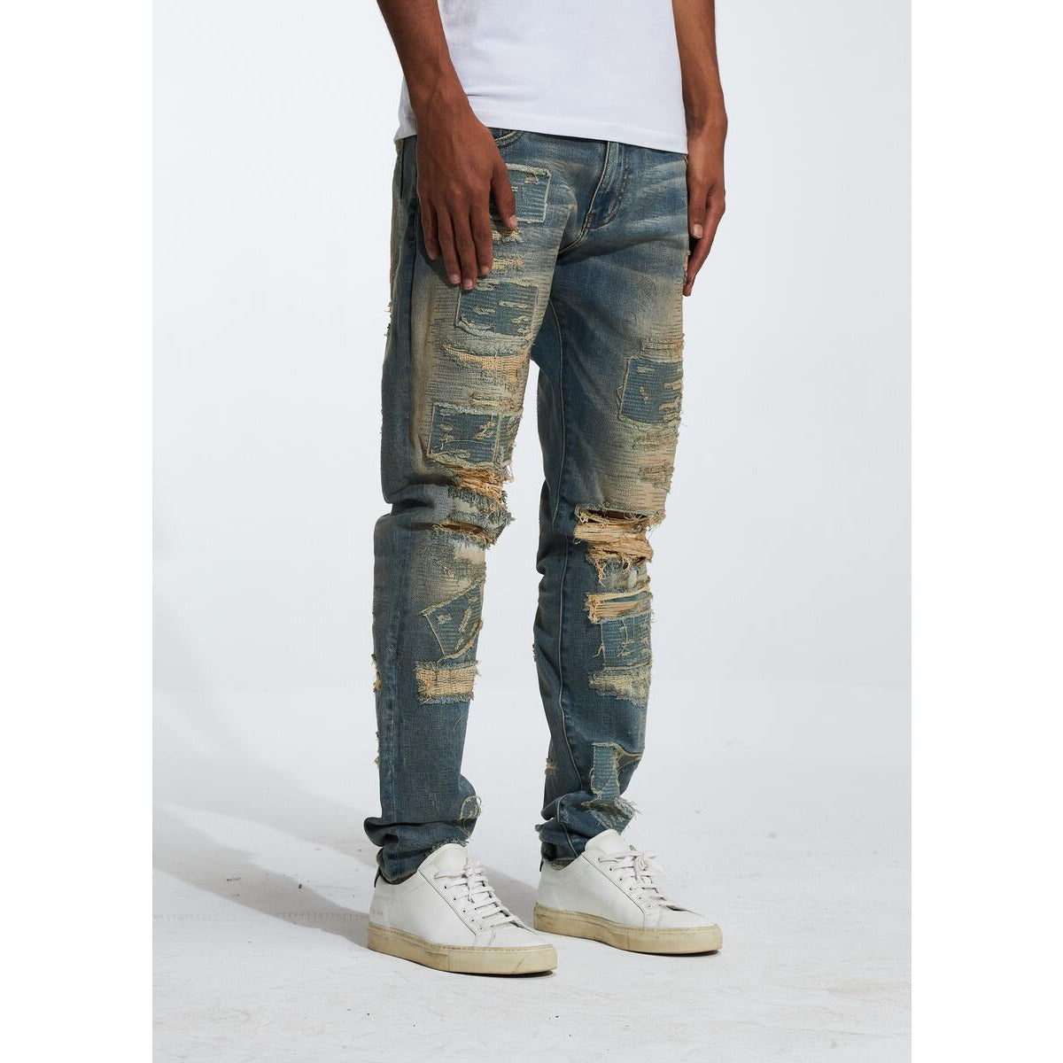 Close-up of Embellish Gemdale Sand Wash Denim in light blue, distressed denim fabric with frayed edges