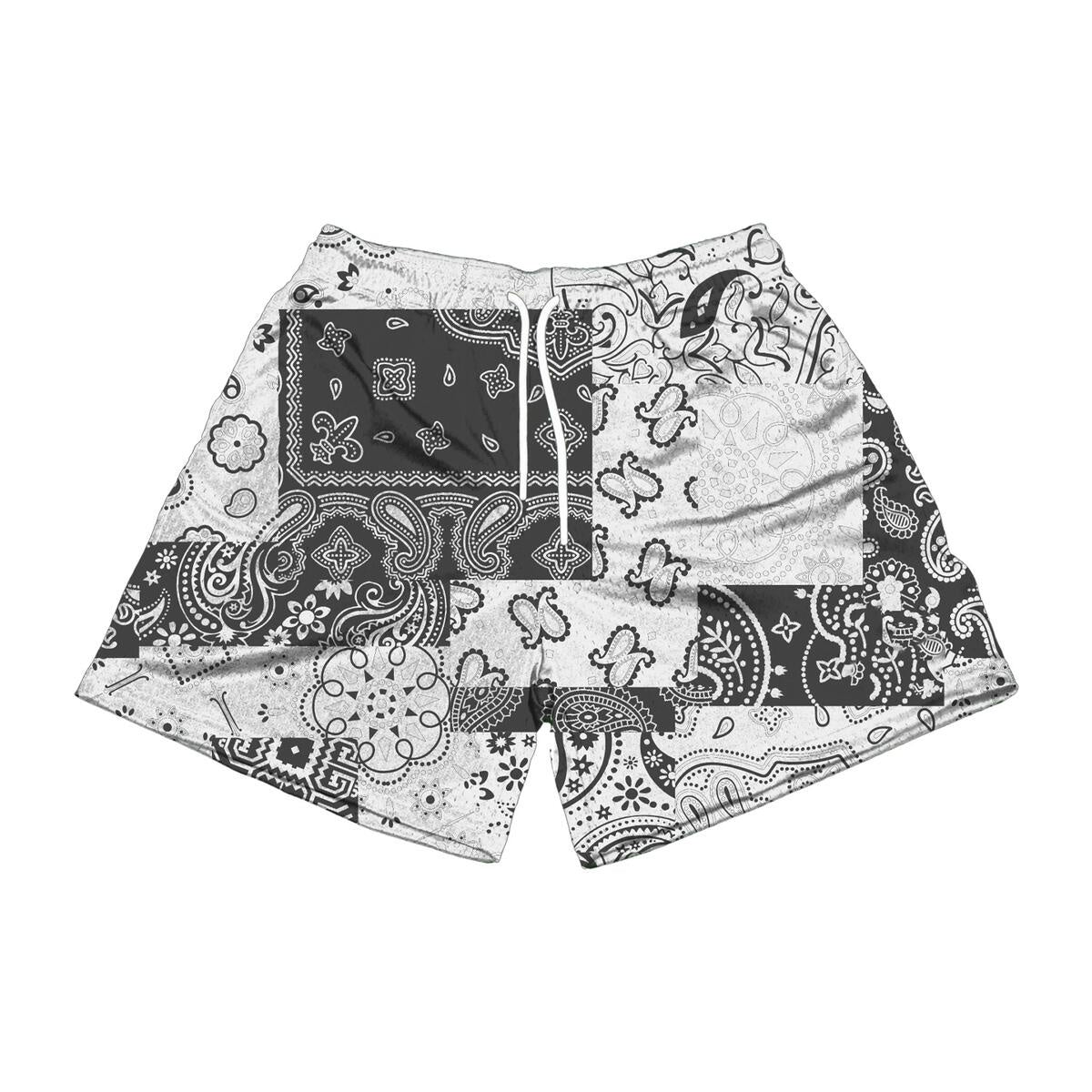 A close-up image of The Edition Brand Paisley Chop White/Black Shorts featuring intricate paisley design and contrasting colors