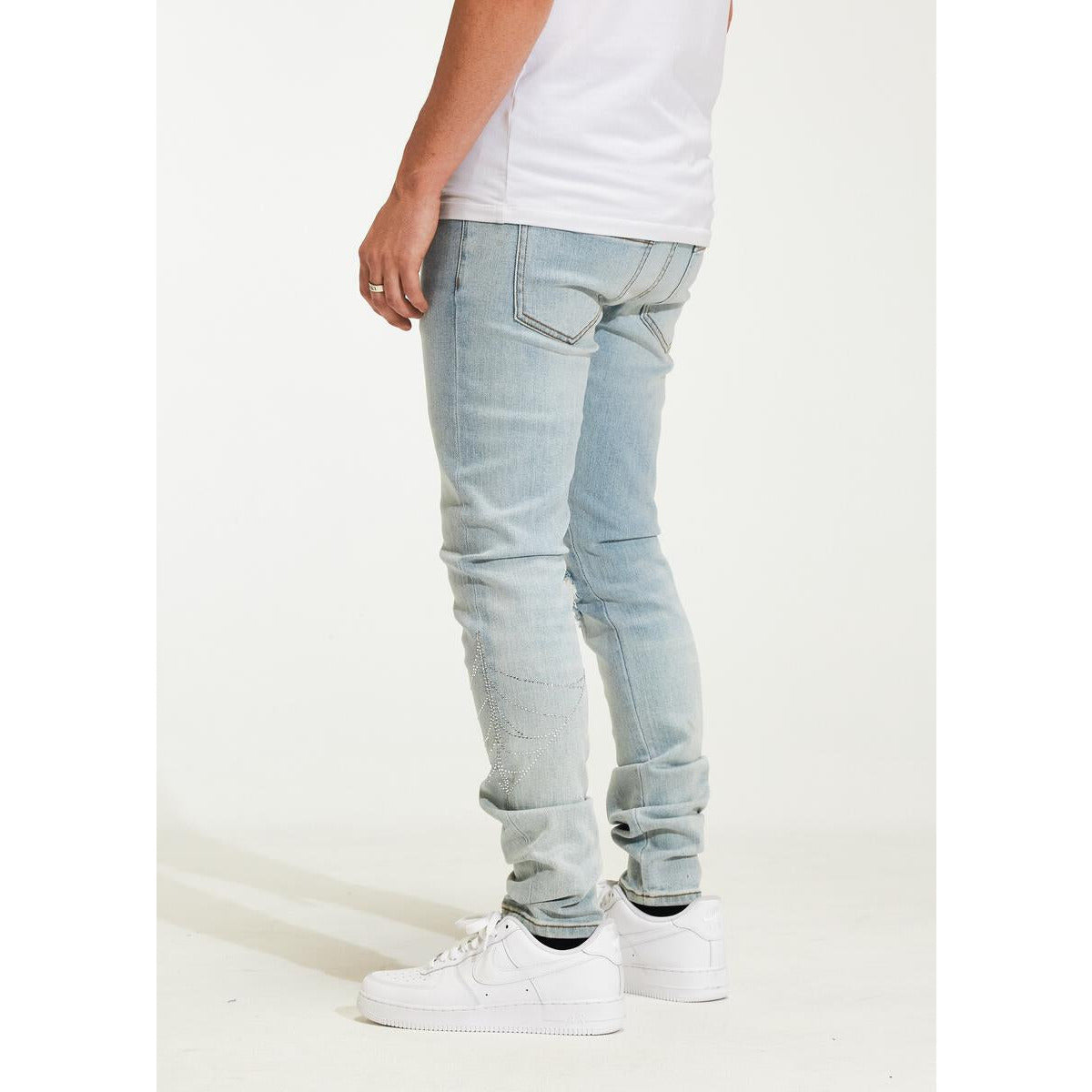 Pair of Crysp Denim Atlantic Light Blue Ripped Jeans (CRYH22-214) laid out flat to show full length and design details