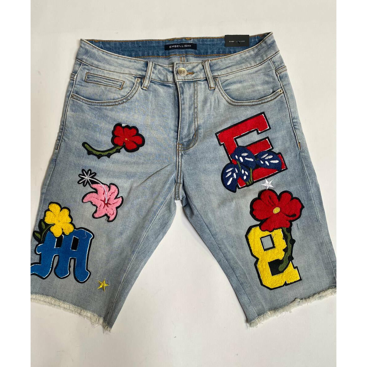 Light blue Nille patch shorts with embellished details for a stylish look