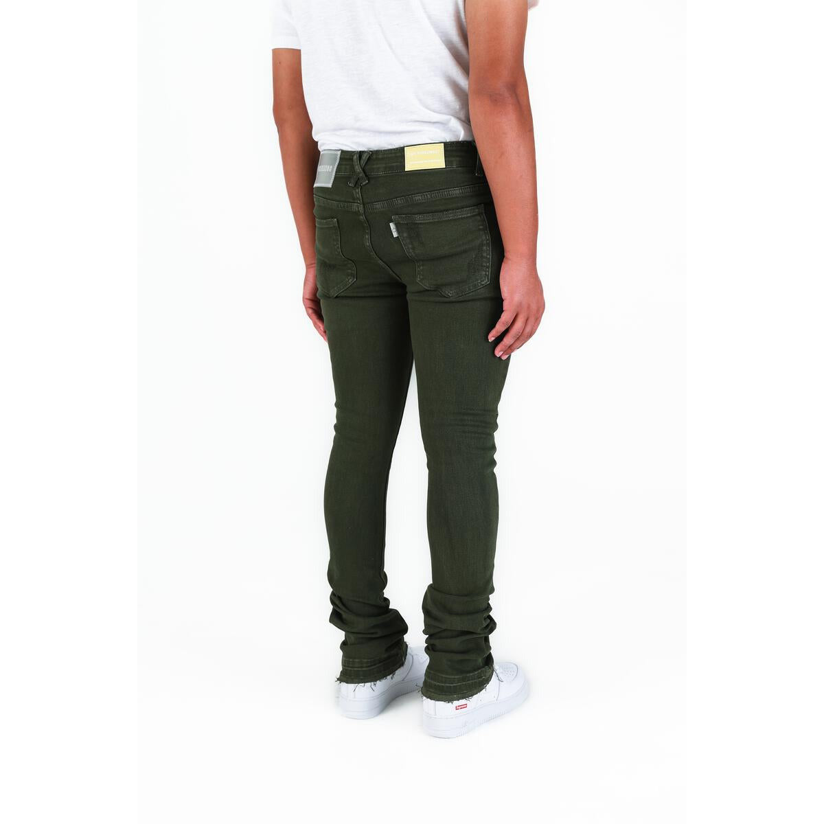 Side view of PHEELINGS Now Or Never Olive Flare Stack Denim showcasing the fitted silhouette and flared leg