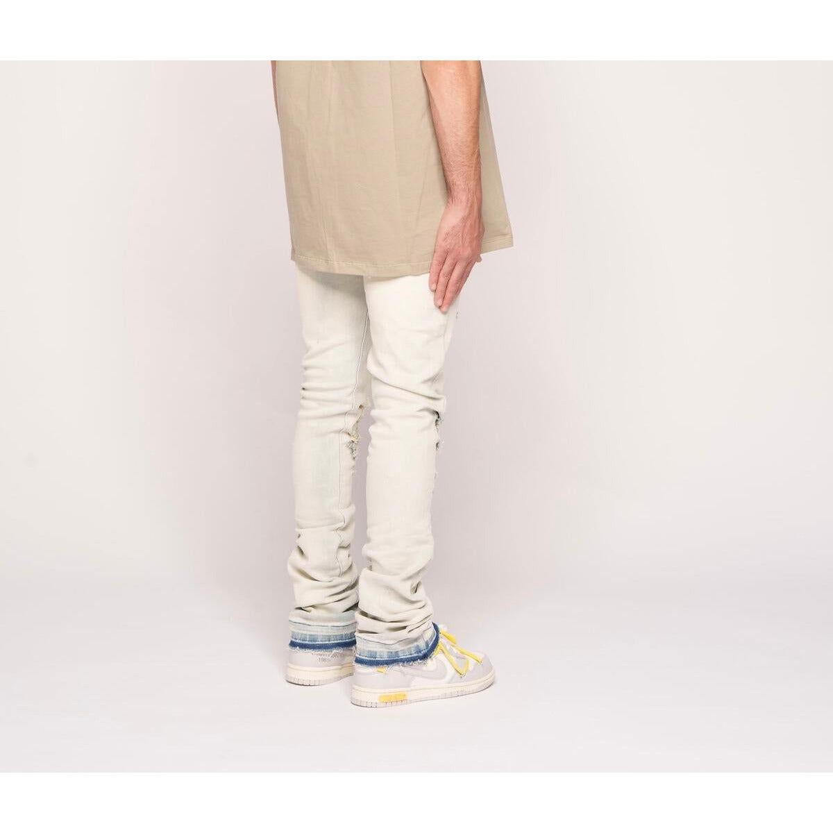 Close-up of the distressed hem and stitching details on PHEELINGS Almost There Light Sand Blue Flare Stack Denim jeans