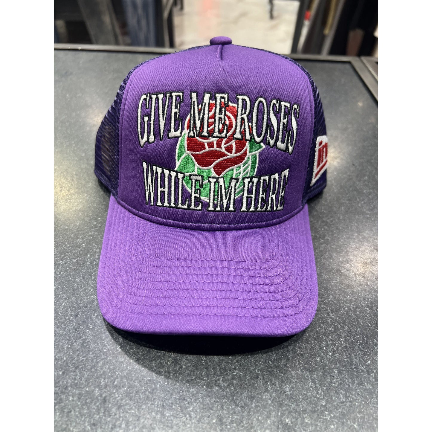 Give Me Roses While I'm Here Trucker Hat in Purple, a stylish and trendy fashion accessory for women