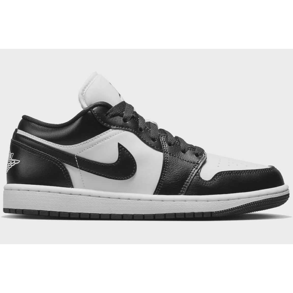 Alt text: White and black Jordan 1 Low sneakers with panda pattern, a stylish and trendy women's footwear option for 2023