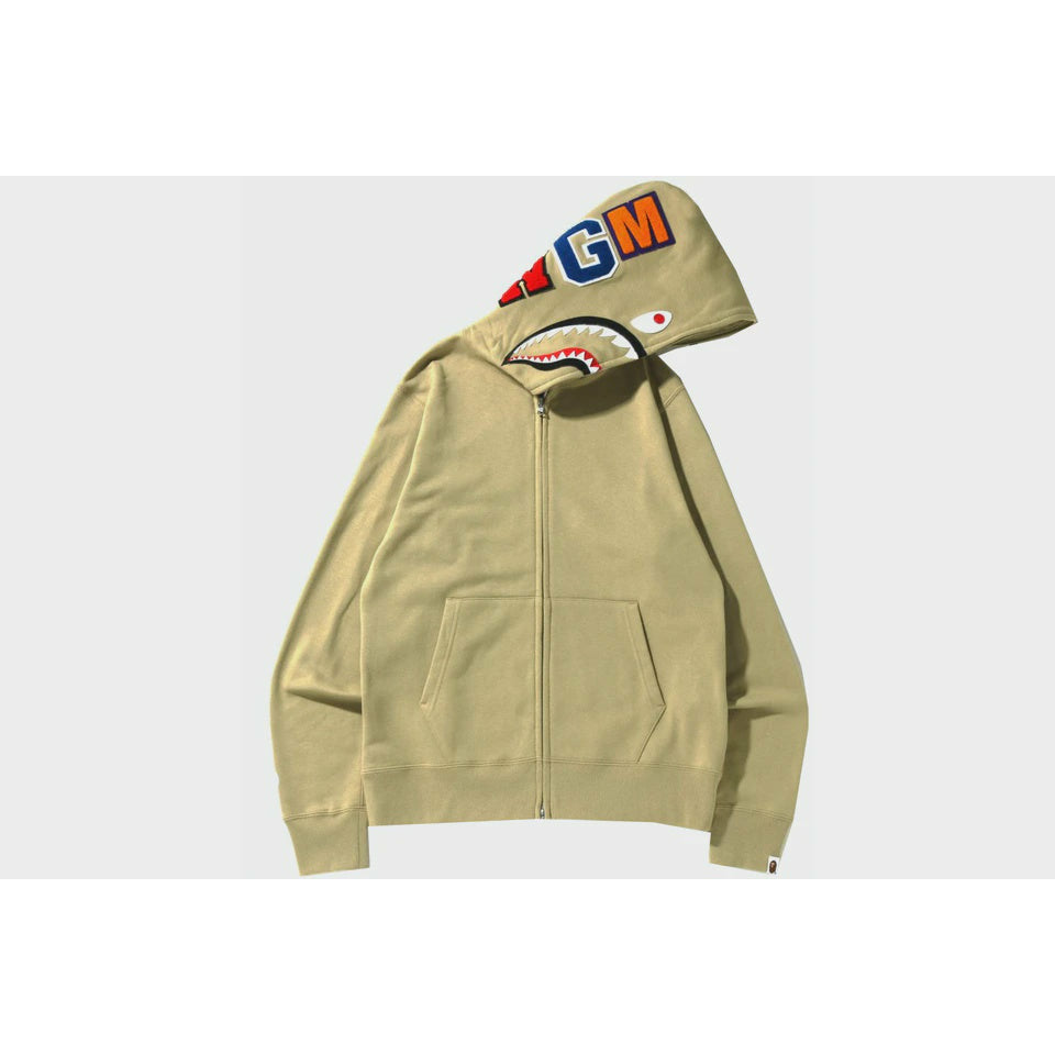 A close-up image of the BAPE Shark Full Zip Hoodie (SS22) in Beige, showcasing the iconic shark face design and full zip closure
