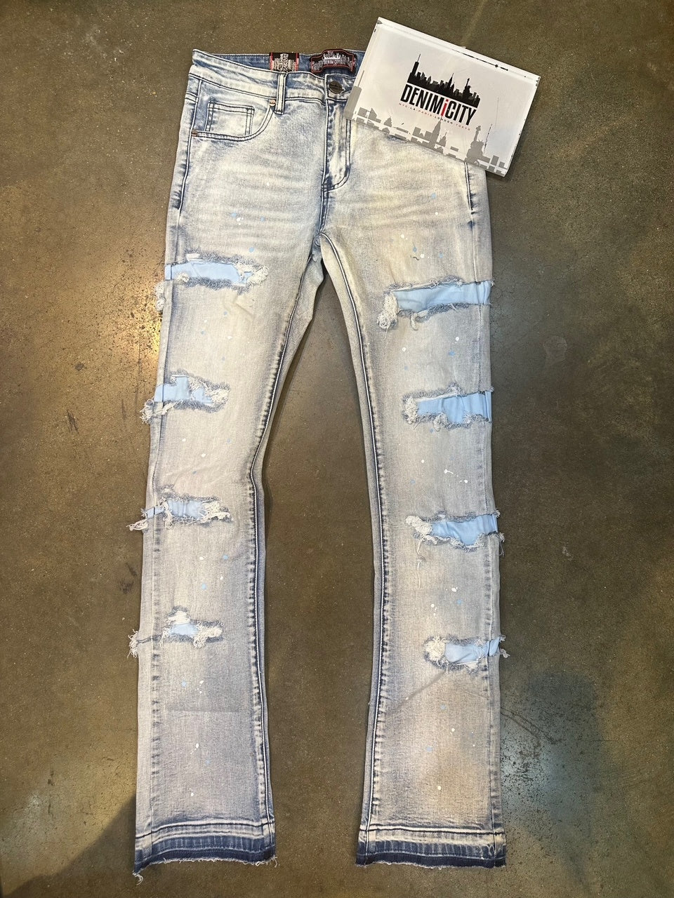 Close-up image of DENIMiCITY Zombie Baby Blue Ripped Light Blue Denim (DNM-K122) showcasing distressed details and light blue wash