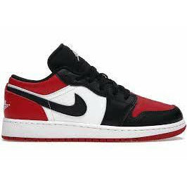 Close-up image of the Jordan 1 Low - Bred Toe (GS) sneakers, featuring a black and red colorway with white accents and a low-cut design for kids