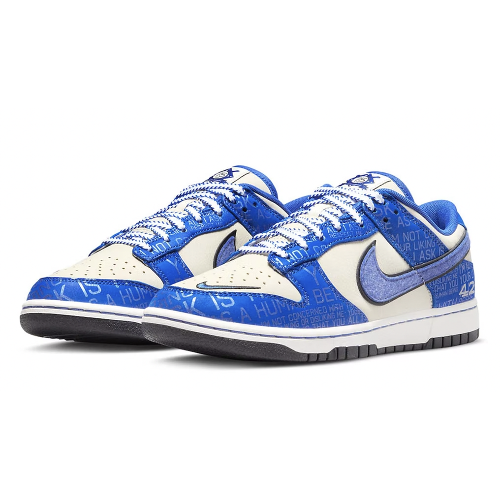 Nike Dunk Low - Jackie Robinson: A black and white low-top sneaker with a stitched logo and baseball-themed design