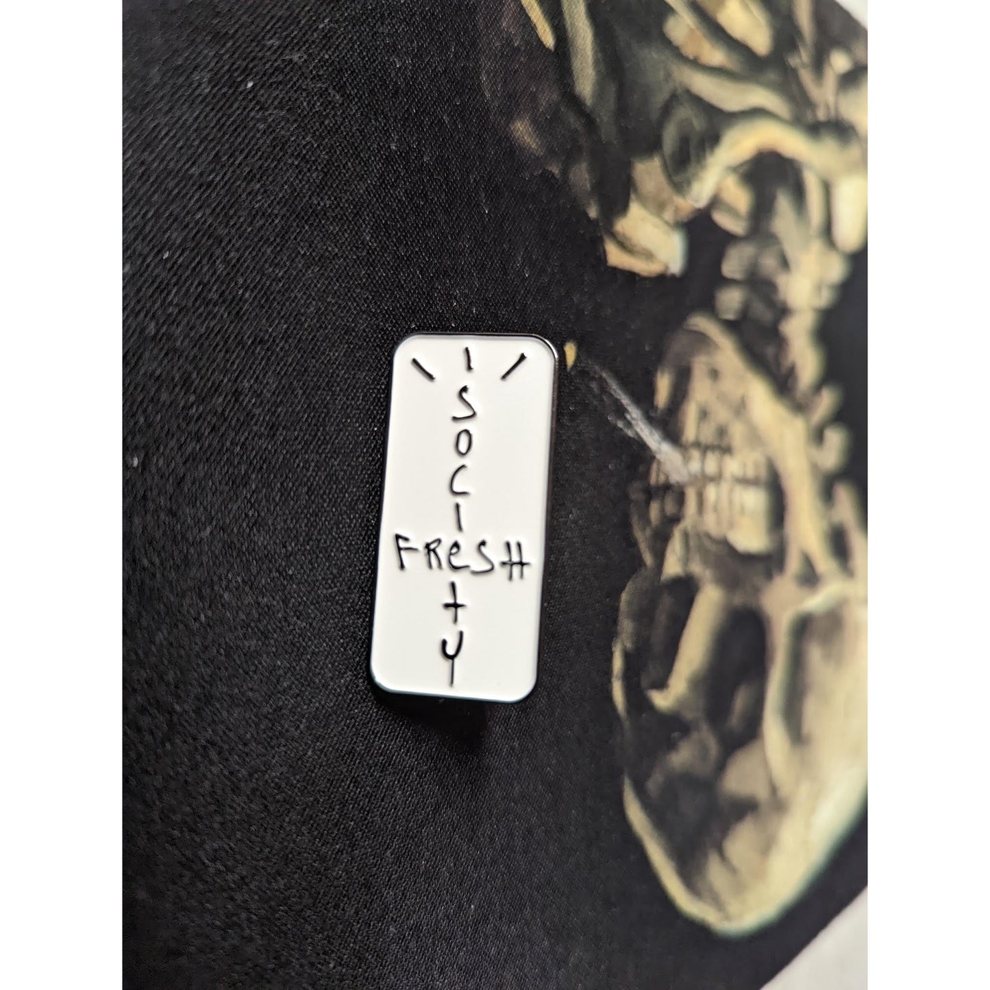 Person wearing Fresh Society Look Mom, I'm Fresh Pin on a backpack while walking