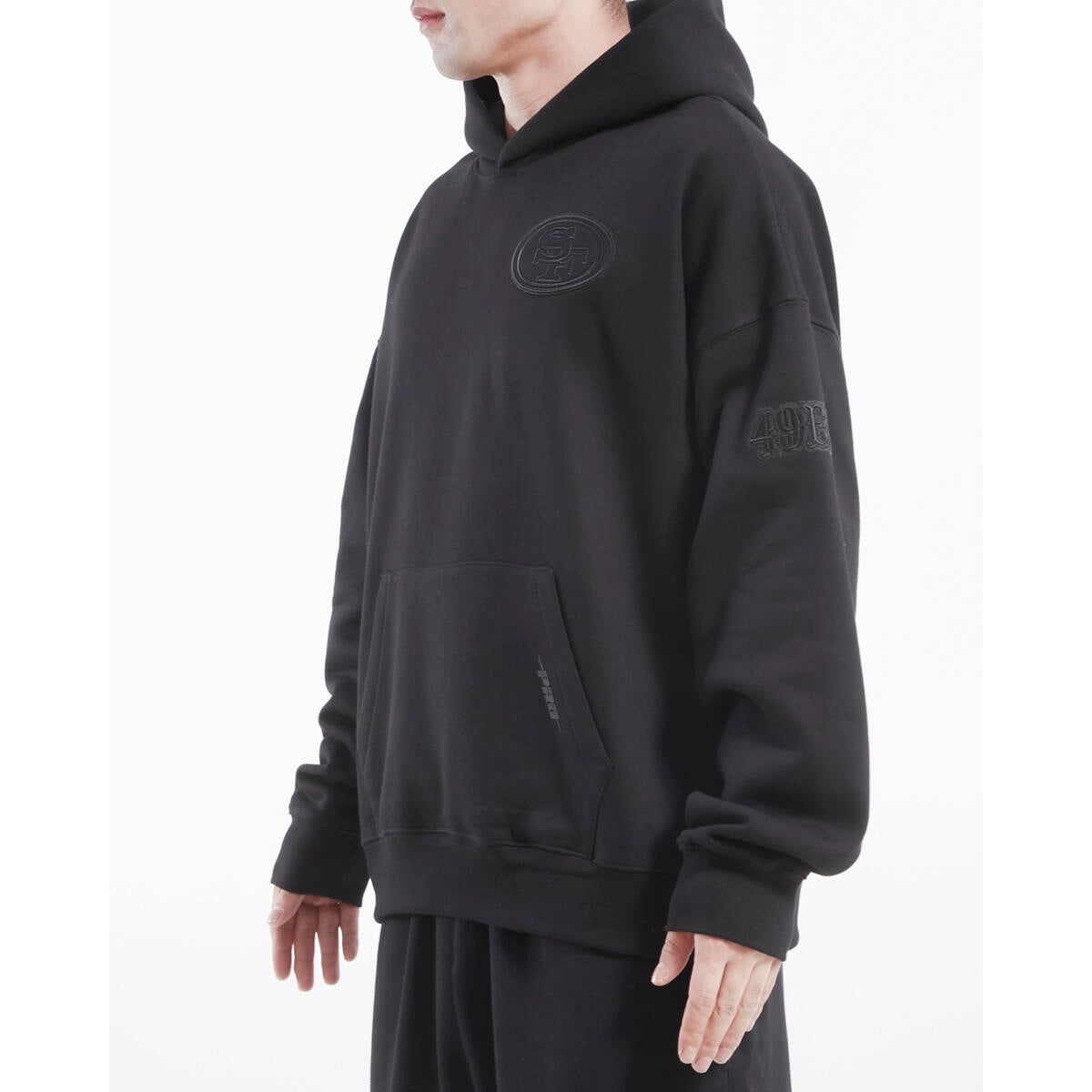 Front view of the black FLC PO hoodie showcasing the San Francisco 49ers logo and relaxed fit