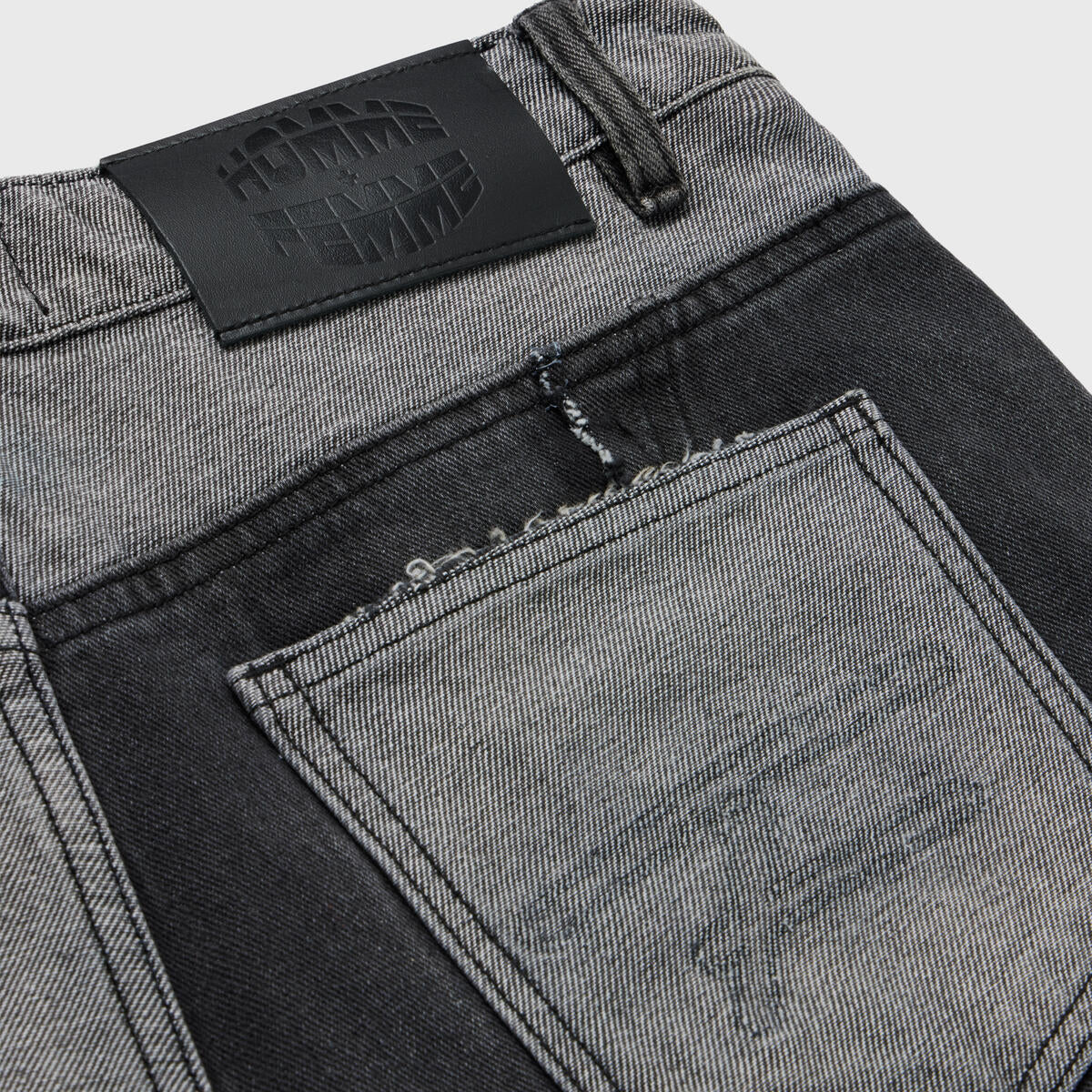  Close-up of the side view of black denim shorts with distressed details