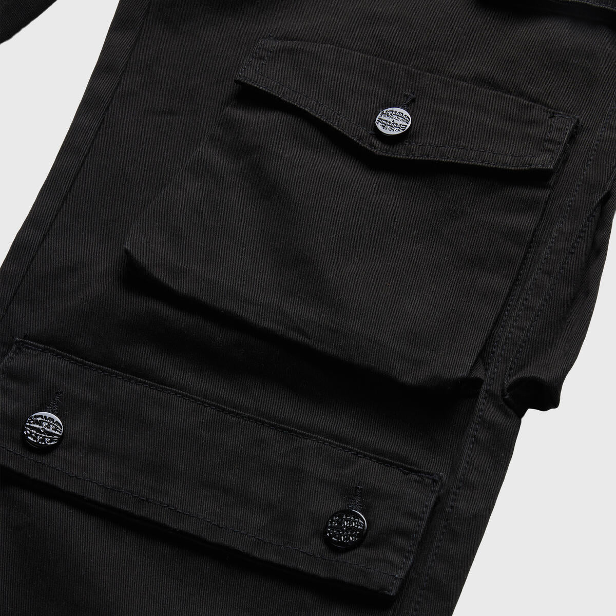 Side view of the Bourne Cargo Pants in black, highlighting the utility pockets and versatile design