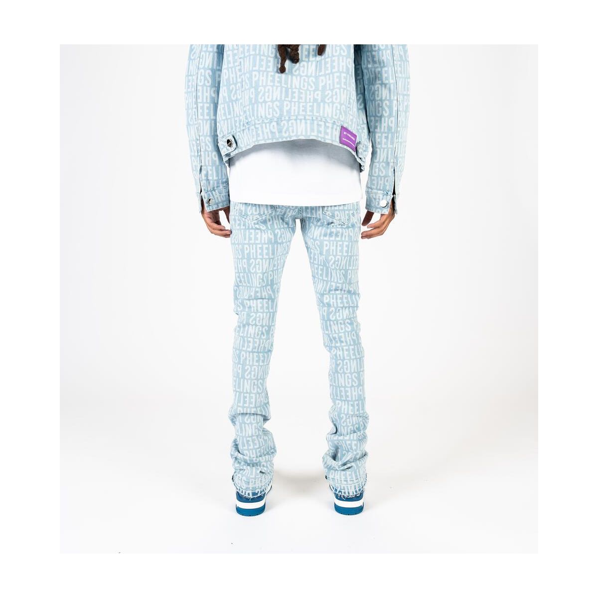 Close-up of the light blue denim fabric with flared silhouette and stack design