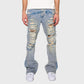 A person wearing Homme + Femme Jagger Denim Jeans in Blue, styled with a white t-shirt and sneakers