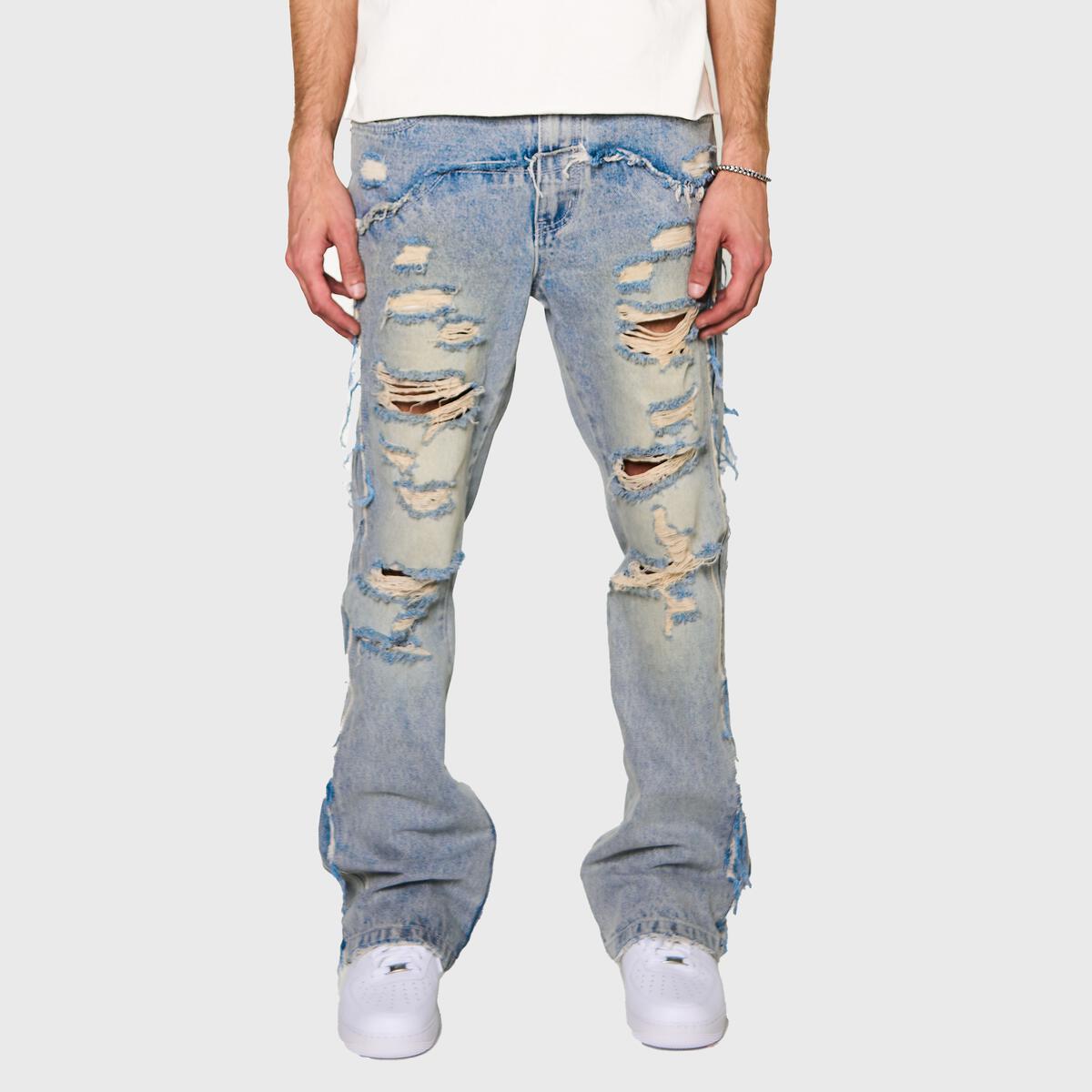 A person wearing Homme + Femme Jagger Denim Jeans in Blue, styled with a white t-shirt and sneakers