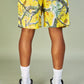 Yellow mesh shorts with 'Politics Branches' design, perfect for casual wear