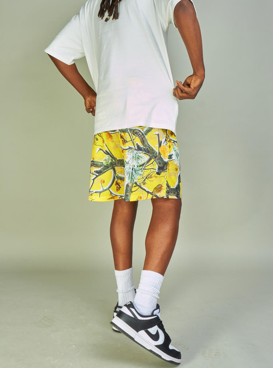  Side view of yellow mesh shorts with pockets and 'Politics' branding