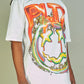 White and orange Politics PLTX Graphic Tee with bold typography design