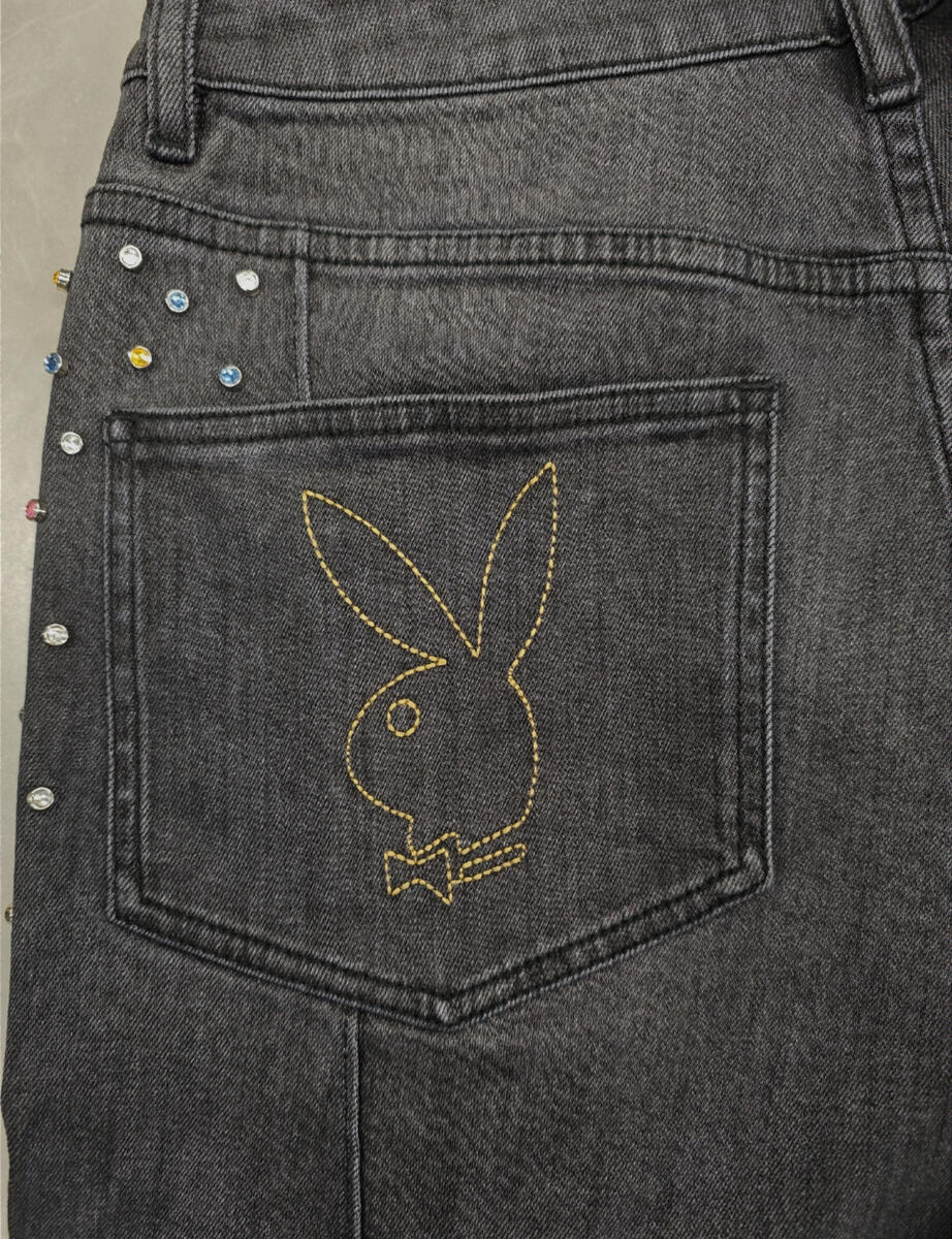 Side view of the Homme + Femme Playboy denim jeans, showcasing the slim fit and black color