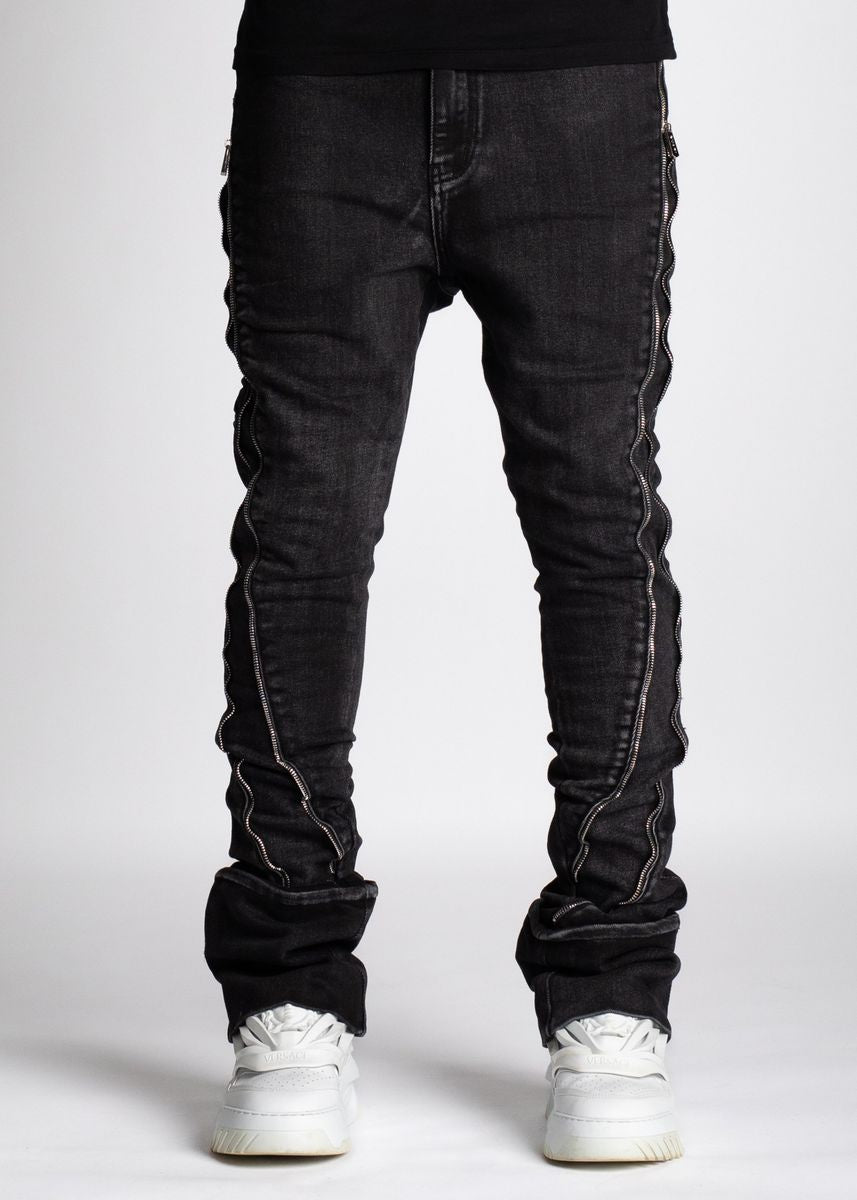 Close-up of stylish Guapi Iron Grey Stacked Zipped Denim Jeans with intricate stitching and zipper details