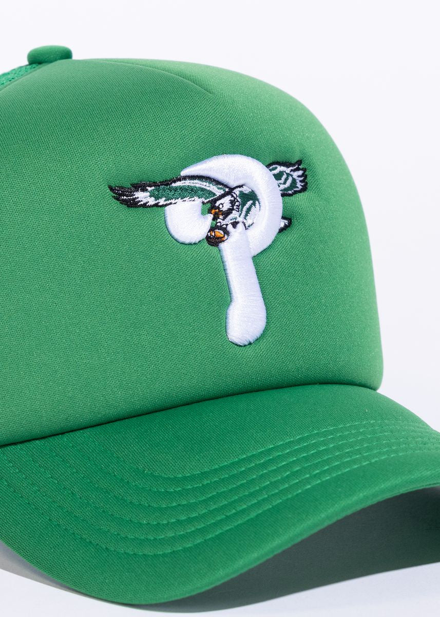 Front view of the Reference Pheagles Trucker Hat in Green, showing embroidered logo and adjustable strap 