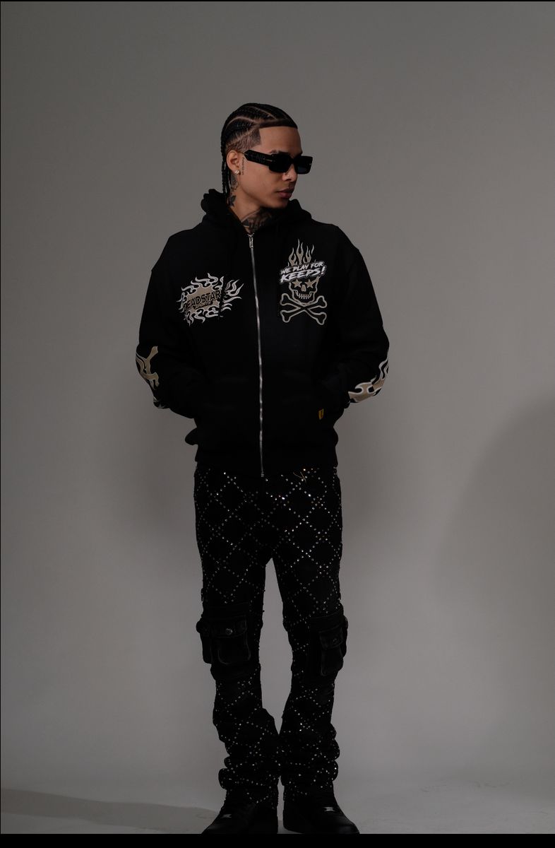 High-quality close-up of black denim fabric and rhinestone embellishments