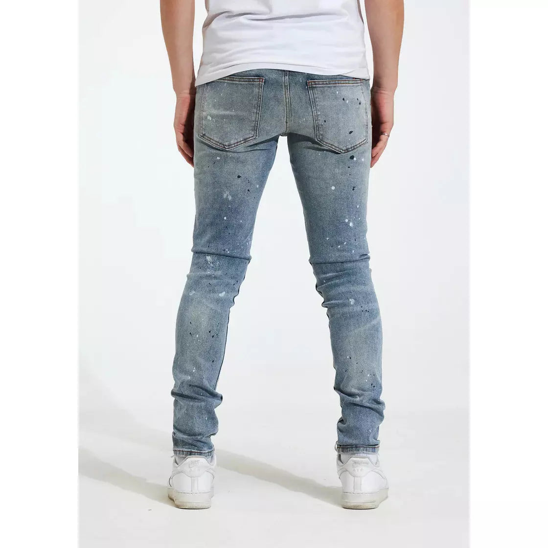 Crysp Denim Blue Arctic Jeans with a focus on the unique tear patterns and distressing