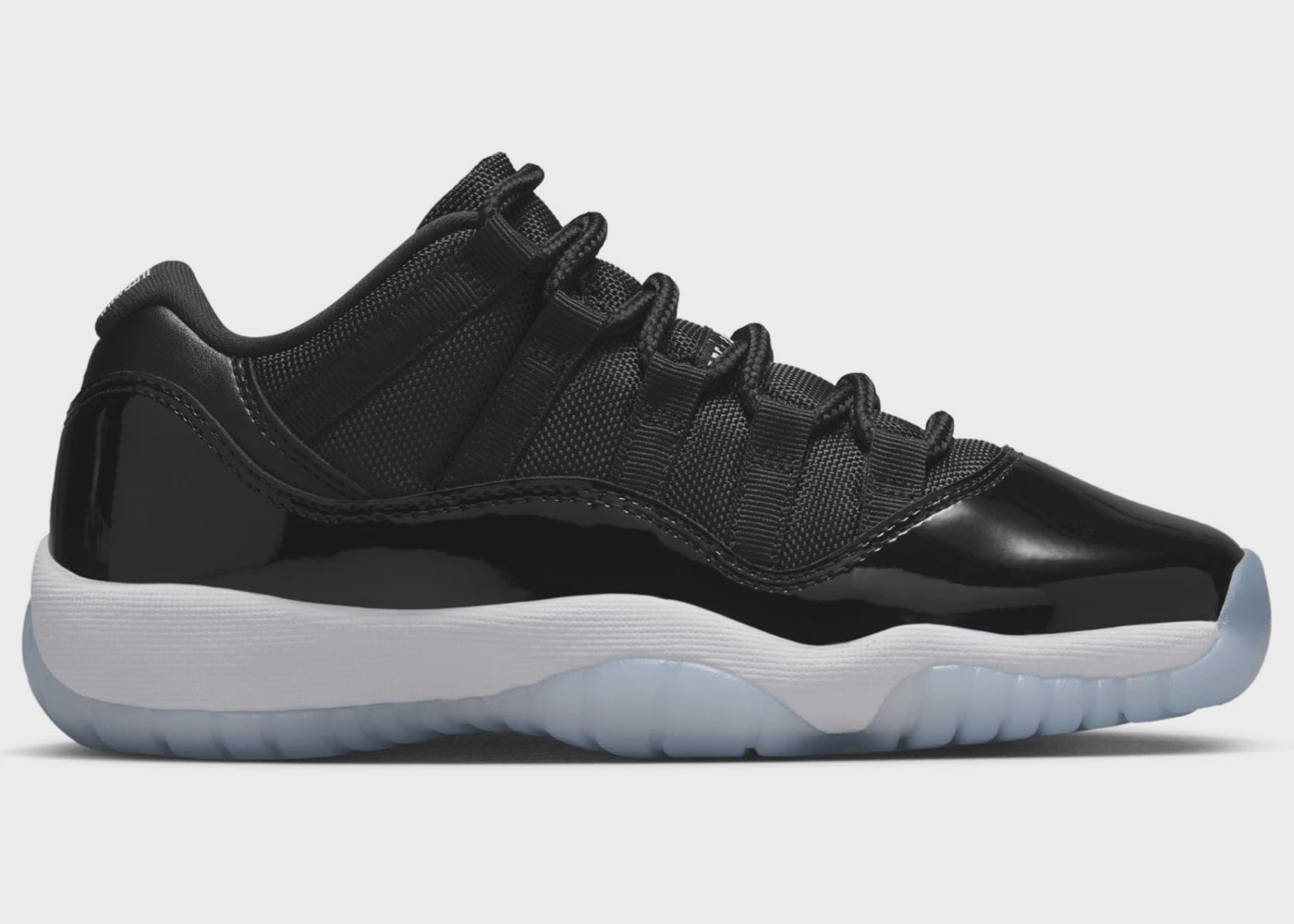 Black and white Jordan 11 Retro Low - Space Jam sneakers for kids with style code FV5121-004