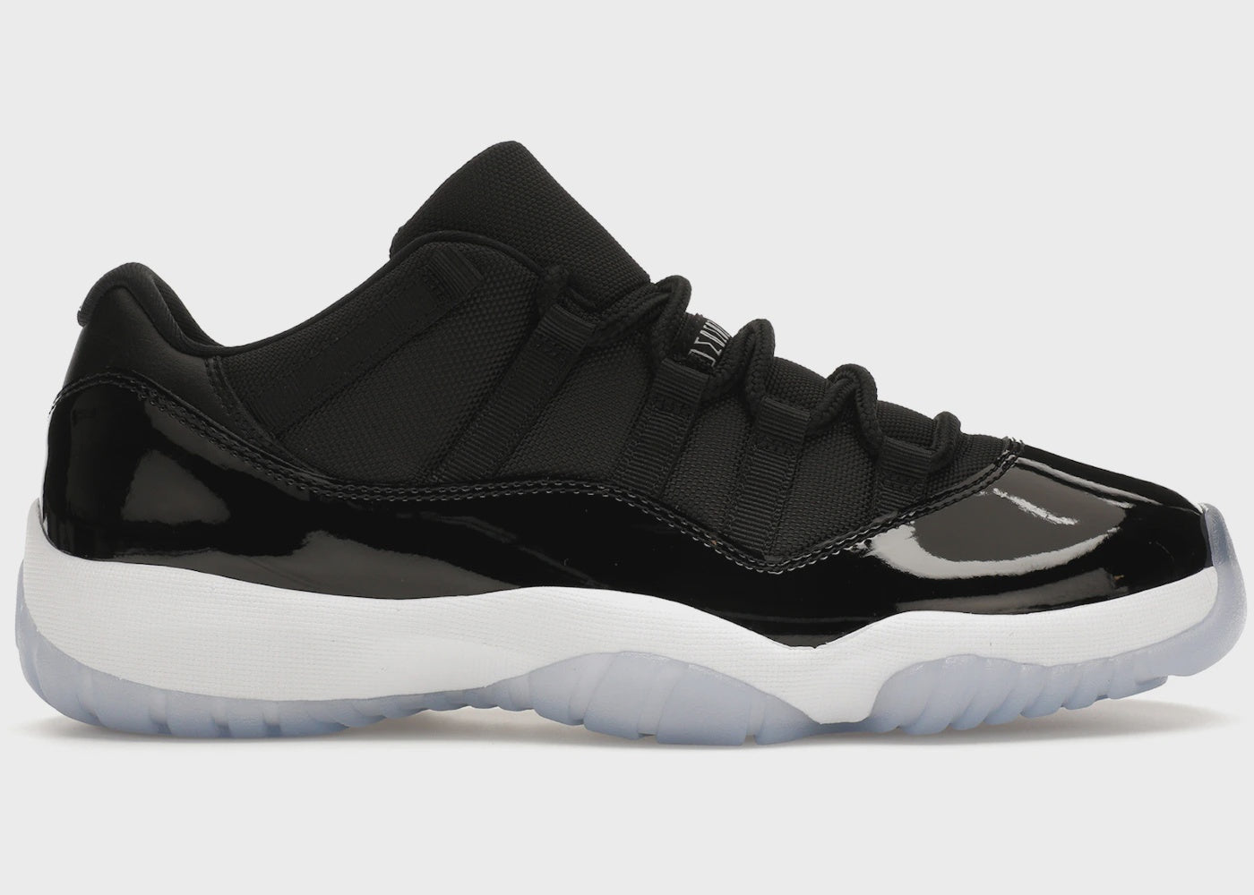 Black and white Jordan 11 Retro Low - Space Jam sneakers with patent leather and icy blue outsole